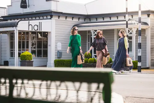 People walking past boutique shops in Greytown village