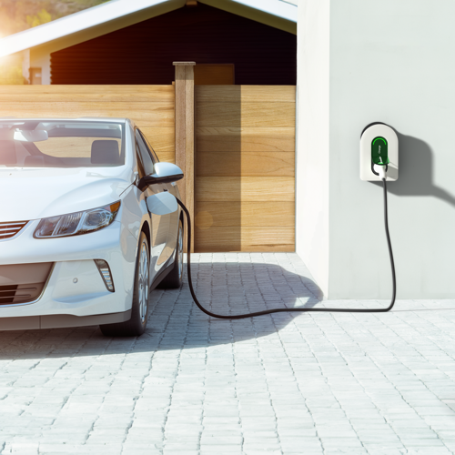 PDL Schneider Charge wallbox EV charger mounted outside a home garage with electric vehicle charging