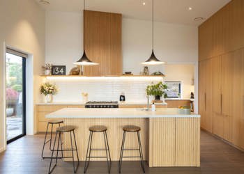 Kitchen With Warm Wood Tones And White Tile Splashback